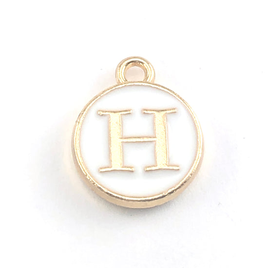round white and gold jewerly charm with the letter H on it