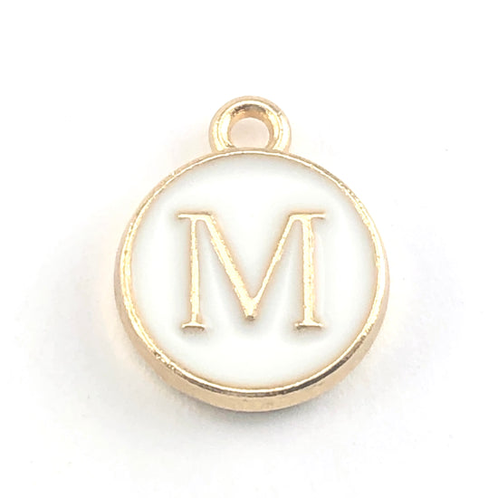 round white and gold jewerly charms with the letter M on them