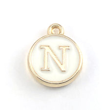 round white and gold jewerly charms with the letter N on them