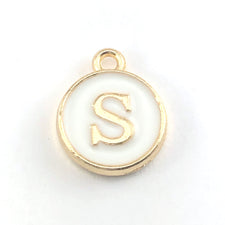 gold and white round jewerly charms with the letter S on them