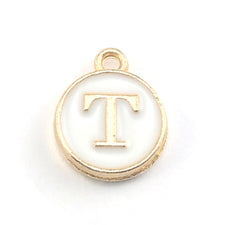 gold and white round jewerly charms with the letter T on them