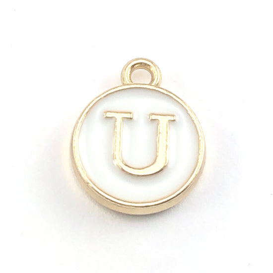 gold and white round jewerly charms with the letter U on them