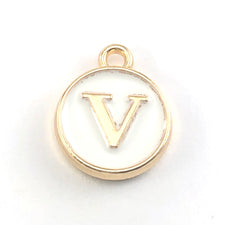 gold and white round jewerly charms with the letter V on them