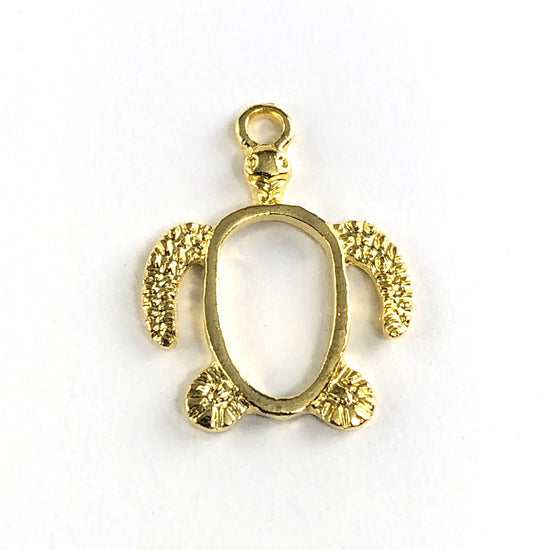 gold colour jewerly bezel in the shape of a turtle