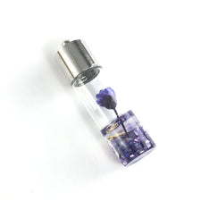 clear glass jewelry pendant with purple flower inside