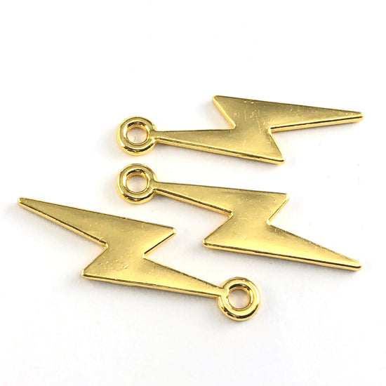 gold jewerly charms shaped like a bolt of lightning