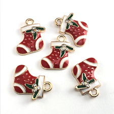 five red, white and green jewrly charms shaped like christmas stockings