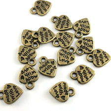 heart shaped bronze jewelry charms with the words made with love on them