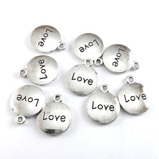 Nine round jewerly charms with the word love on them