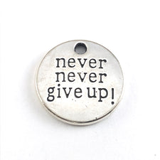 round silver jewerly charm with the words never never give up on it