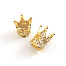 Two gold colour jewerly beads shaped like crowns with clear rhinestones on them