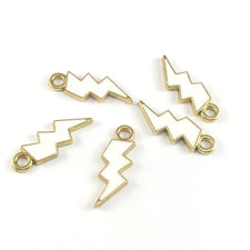 Five lightning shaped white and gold jewelry pendant charms