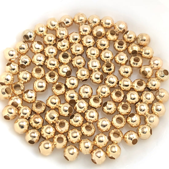 light gold coloured round jewelry beads