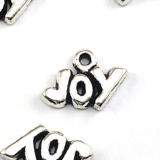 antique silver colour jewerly charms that say Joy