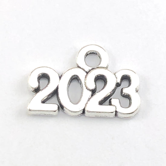 antique silver jewelry charm shaped in the number 2023