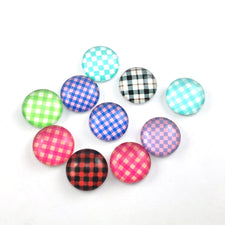 round glass cabochons that are a mix of plaid patterned colours