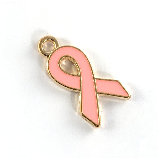 pink and gold jewelry charm shaped like an awareness ribbon