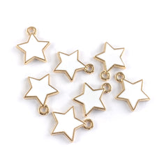 Seven white and gold star shaped jewerly charms