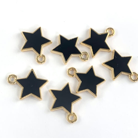 Seven black and gold star shaped jewelry charms