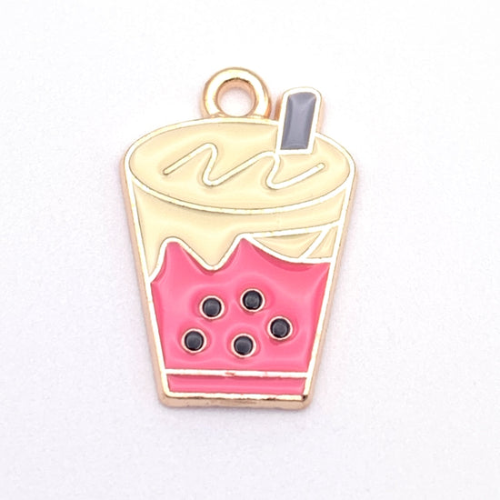 yellow, pink and gold jewelry charm that looks like a glass of bubble tea