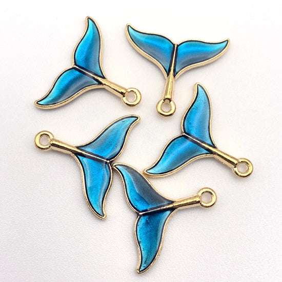 blue and gold whale tail shaped jewerly charms