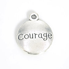 round silver jewerly charm with the word courage on it