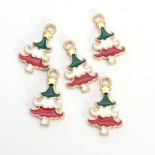 Five green white red and gold jewerly charms shaped like christmas trees