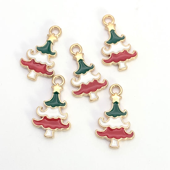 Five green white red and gold jewerly charms shaped like christmas trees