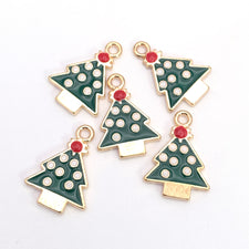 Five christmas tree shaped jewelry charms that are red, green, white and gold in colour