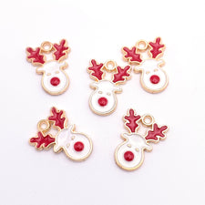 Five red white and gold colour jewerly charms shaped like a deer head