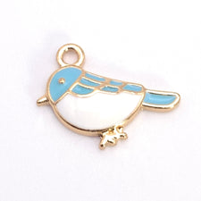 jewelry charm shaped like a bird that is blue, white and gold