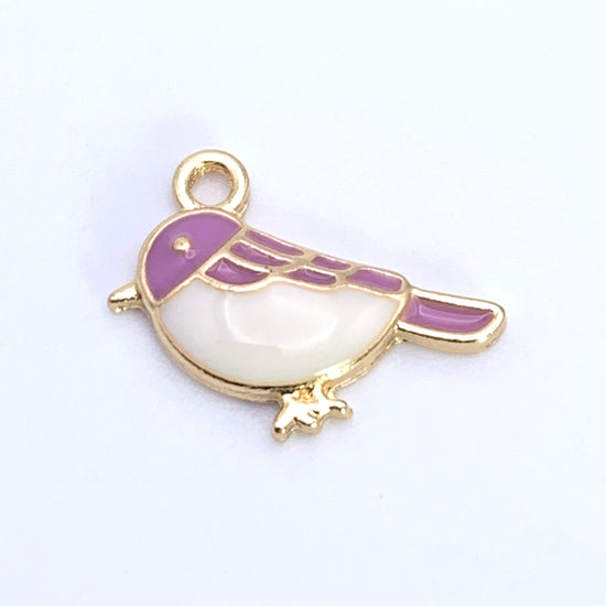 jewelry charm shaped like a bird that is purple, white and gold