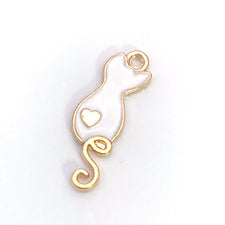 White and gold jewerly charms shaped like cats