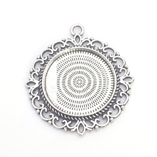 round antique silver closed back bezel with flower shaped edging