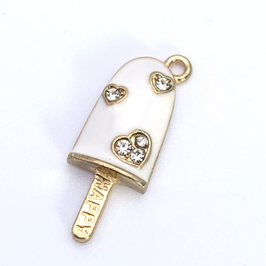 White and gold jewerly charms shaped like ice cream bars