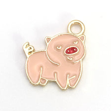 pink and gold jewerly charm that looks like a pig