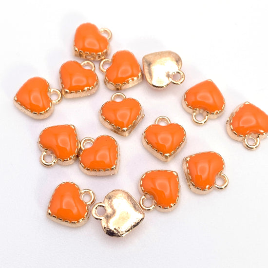 small heart shaped jewerly charms that are orange and gold