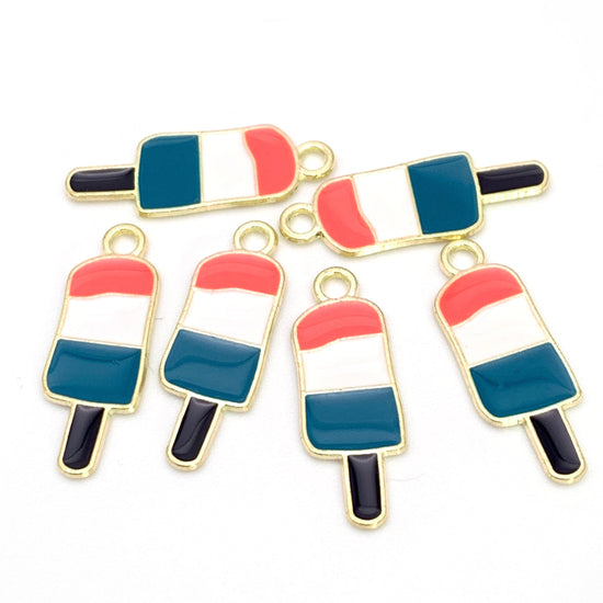 Six popcycle shaped jewelry charms that are gold, pink, white teal and black