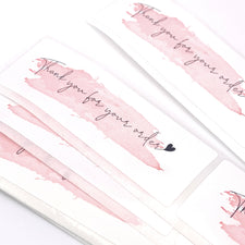 rectangle shaped white and pink stickers that say Thank you for your order