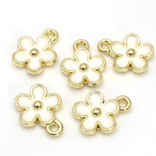 white and gold flower shaped jewerly charm