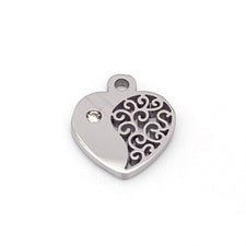 heart shaped silver jewelry charm with clear rhinestone in it