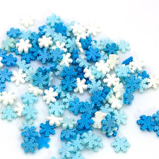 white, light blue and medium blue snowflake shaped plastic pieces