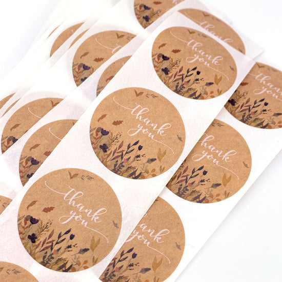 round beige stickers that have thank you on them