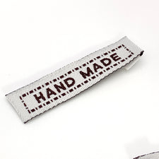 brown and white rectangle tag that says hand made