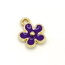purple and gold coloured flower shaped jewerly charm