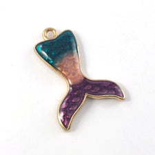 mermaid tail shaped pendant that is gold, blue, purple and pink