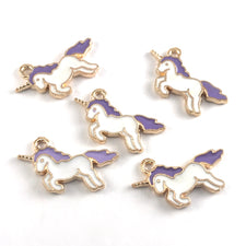 purple and white charms shaped like unicorns