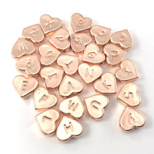 26 heart shaped rose gold colour beads with letters on them