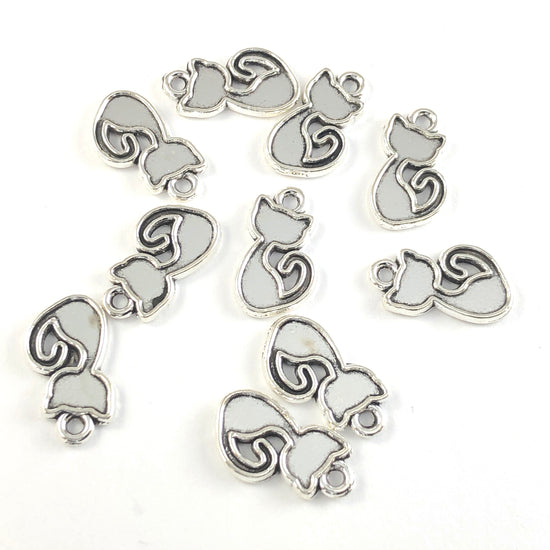 silver colour charms shaped like cats