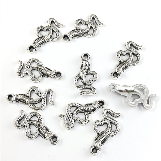 silver colour jewerly charms that look like snakes